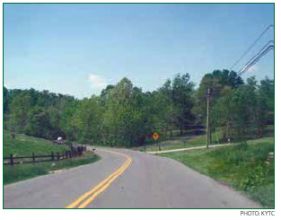 A horizontal curve on a rural, two-lane roadway. Photo: KYTC
