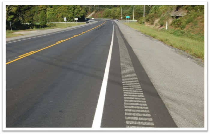 KYTC photograph of an existing rumble strip and stripe application along a rural undivided two-lane road.
