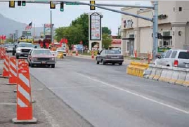Photo of a work zone at an intersection where opposing traffic is divided by cement barriers.