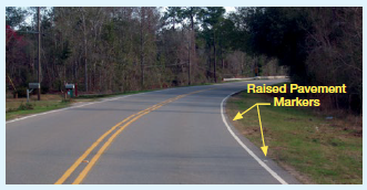 A two-lane curving rural roadway with the locations of RPMs indicated outside the white edgeline.