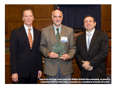 Tony Furst and Greg Cohen pose with William Britnell after presenting an award to Connecticut DOT for their rotary conversion to a roundabout at Routes 80 and 81.