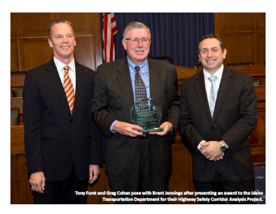 Tony Furst and Greg Cohen pose with Brent Jennings after presenting an award to the Idaho Transportation Department for their Highway Safety Corridor Analysis Project.