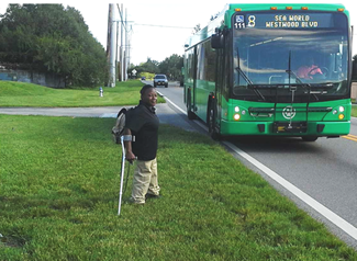 A disabled woman accessing a LYNX bus.