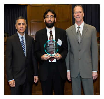 Victor Mendez and Tony Furst pose with Adnan Qazi after presenting an award to Arkansas State Highway and Transportation Department forImproving Interstate Safety with Pavement Surface Treatments.