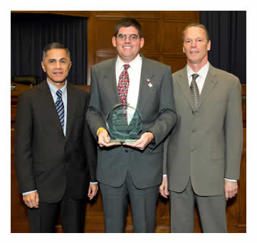 Victor Mendez and Tony Furst pose with John Gianotti after presenting an award to Texas Department of Transportation, San Antonio for TransGuide Wrong-Way Driver Project.