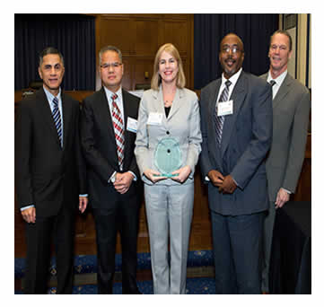 Victor Mendez and Tony Furst pose with the Orange County Florida Public Works Department team (from left  R. Ng, C. Lofye, D. Johnson) after presenting an award to  Orange County Public Works Department, Traffic Engineering Division  for Texas-Americana Road Safety Small Area Study.