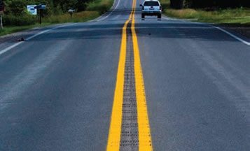 A rural two-lane roadway treated with a center line rumble strip.