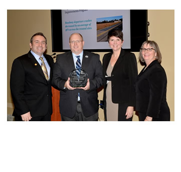 Photo: Greg Cohen, Brandye L. Hendrickson and Beth Alicandri pose with Adam Weiser after presenting an award to Delaware's Department of Transportation for its High-Friction Surface Treatment Systemic Safety Improvements Program.