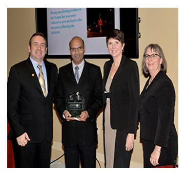 Photo: Greg Cohen, Brandye L. Hendrickson and Beth Alicandri pose with Dr. Raj Ponnaluri after presenting an award to Florida's Department of Transportation for its Wrong-Way Driving Mitigation Initiative.