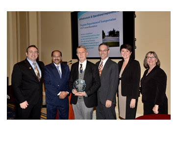 Photo: Greg Cohen, Brandye L. Hendrickson and Beth Alicandri pose with Sunil Taori, Ivan Horodyskyj & Randy Dittberner after presenting an award to Virginia's Department of Transportation for its Instant Roundabout.