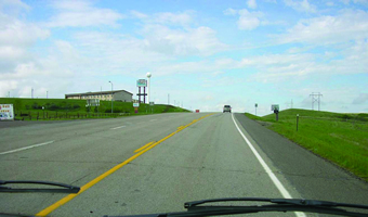 The photo shows US 12 at Grand River Casino, near Mobridge, SD: a three-lane rural road on a gradient, wtih full-width paved shoulders.