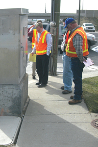 Photo of Road Safety Audit team members inspecting a traffic signal cabinet.