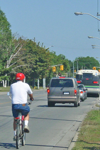 Photo of cyclist traveling on roadway.