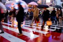 Pedestrians using crosswalk in the rain