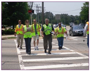 Photo of RSA team crossing a multi-lane street in a pedestrian crosswalk.