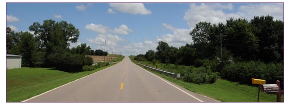 Photo of two-lane rural roadway stretching into the distance.