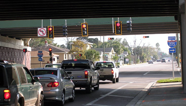 Stopped vehicles at a signalized intersection in which the signal heads have retroflective backplates.