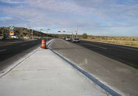 Photo 2 is looking north along NM 30 toward a recently improved intersection adjacent to a convenience store/gas station. The full traffic signal was in place, but not operational, at the time of the audit.