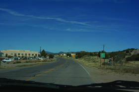 Two photos showing views of roadways from the Jemez Pueblo RSA site. Photo 1 is looking north along NM4 at the entrance to the Pueblo of Jemez. NM4 is predominantly a two-lane rural road with wide shoulders, with a speed limit of 30 mph along this segment.
