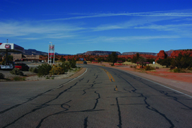 Photo 2 is looking north along NM4 at the Red Rocks recreational area. Roadside land uses include the commercial area (service station and Walatowa Visitors Center) visible at left and the recreational area (where small-scale vending takes place during the summer) at right. The speed limit along this segment of the highway is 50 mph