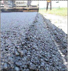 Close-up photo of asphalt SafetyEdge immediately behind the paver, before roller.
