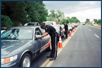 Photo of police officers at a traffic checkpoint.