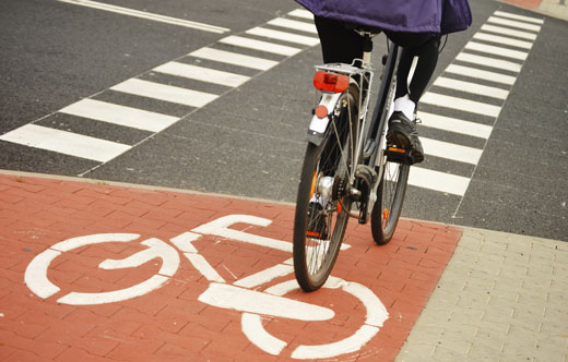 Photo of someone riding a bicycle in a designated bike lane.
