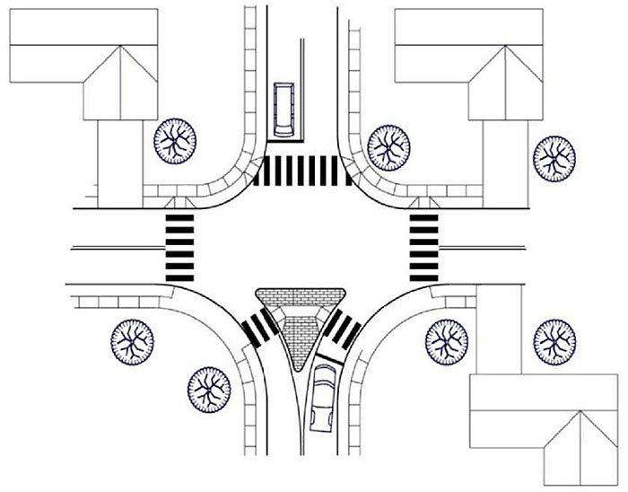 Figure 3.24.2. Forced Turn Island Schematic. This figure contains a schematic of an intersection which uses a median island on the lower leg. This triangular island forces traffic in the right lane to turn right and prevents traffic in the left lane from crossing the intersection and entering the lower left lane. The other legs are free of any islands. A vehicle waits in the left lane of the upper leg.
