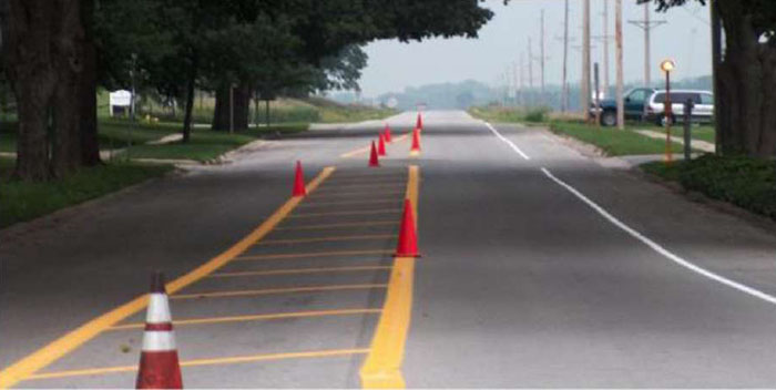 Figure 5-4 Pavement markings during installation of a painted center median to narrow lanes in Union, IA (Image Source: Neal Hawkins)