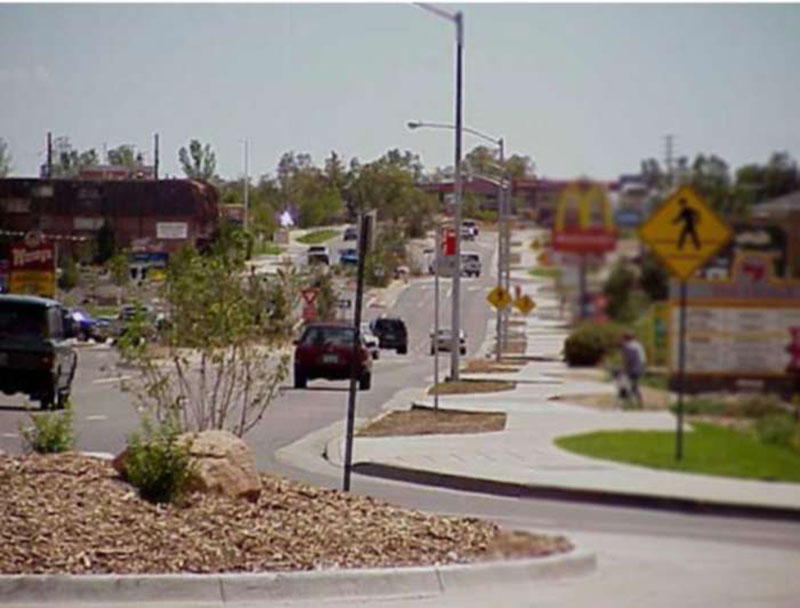 Photo of South Golden Road after numerous improvements featuring roundabouts and other safety measures where the design supports speed compliance even with a 25 mph speed limit in addition to enhancing access, operations, and safety for all users.