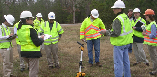 Transportation professionals wearing retroreflective vests conducting a field review.