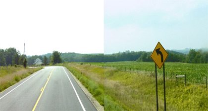 Photograph - Photograph displaying a rural two-lane highway with a useable composite shoulder and a large, relatively flat clear zone.