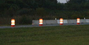 Barrels in a row separating work zone from traffic