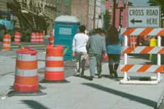 Picture of pedestrians walking through a work zone area